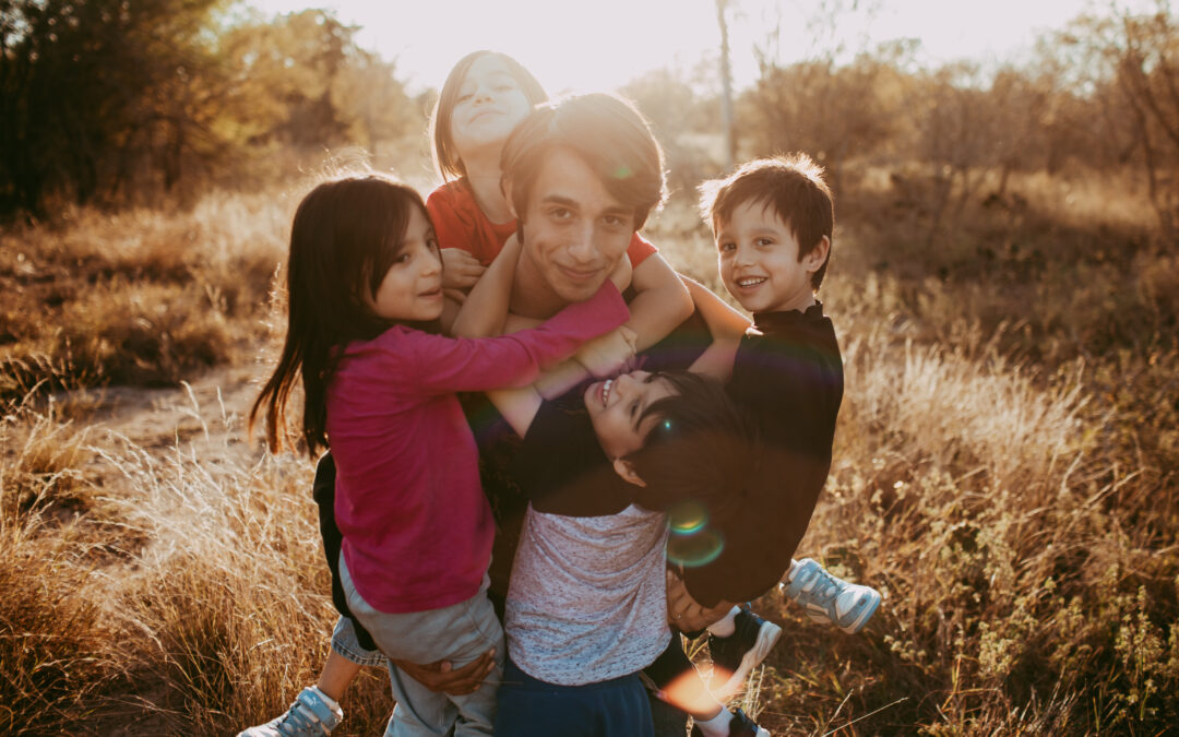 Photo of all 5 Saenz Kids smiling at the camera.